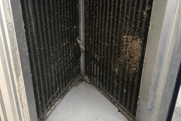 HVAC coil with visible dirt and debris buildup before cleaning